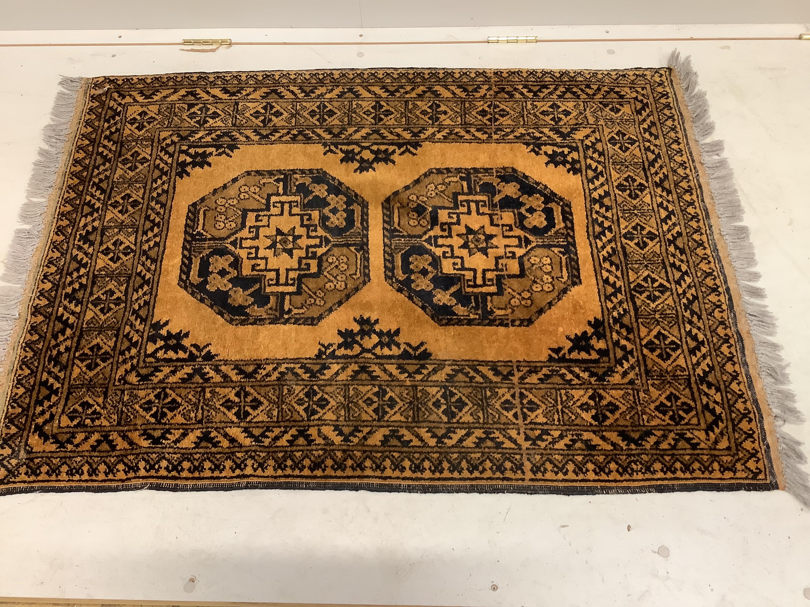 A Bokhara red ground rug and an Afghan rug, larger 184 x 120cm